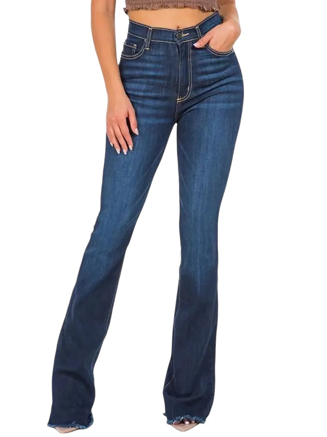 a woman wearing a brown top and jeans