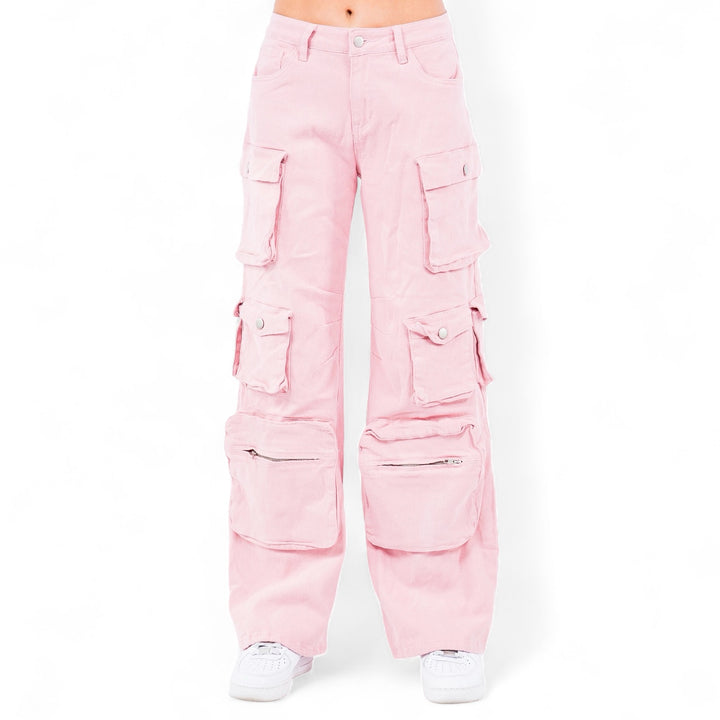 a woman wearing pink pants and white sneakers