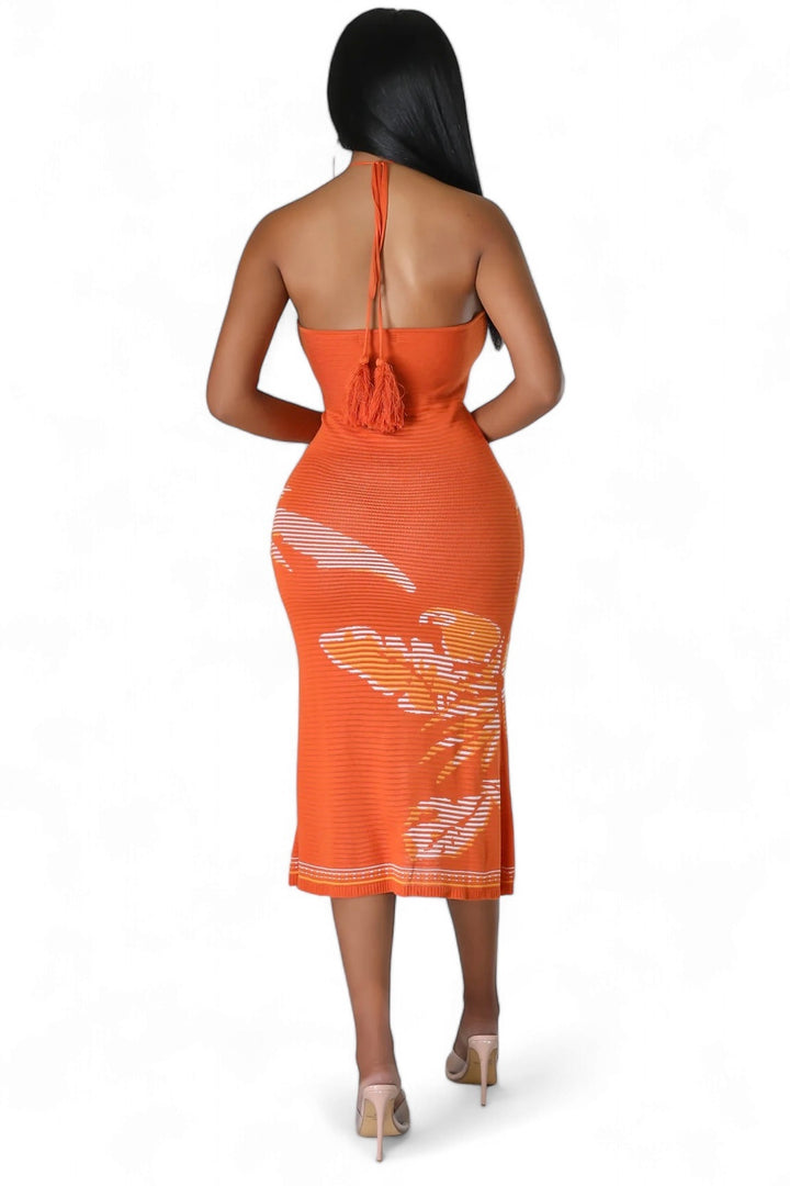 a woman in an orange dress is standing