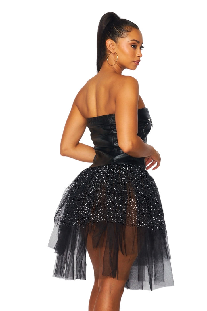 a woman wearing a black dress and high heels