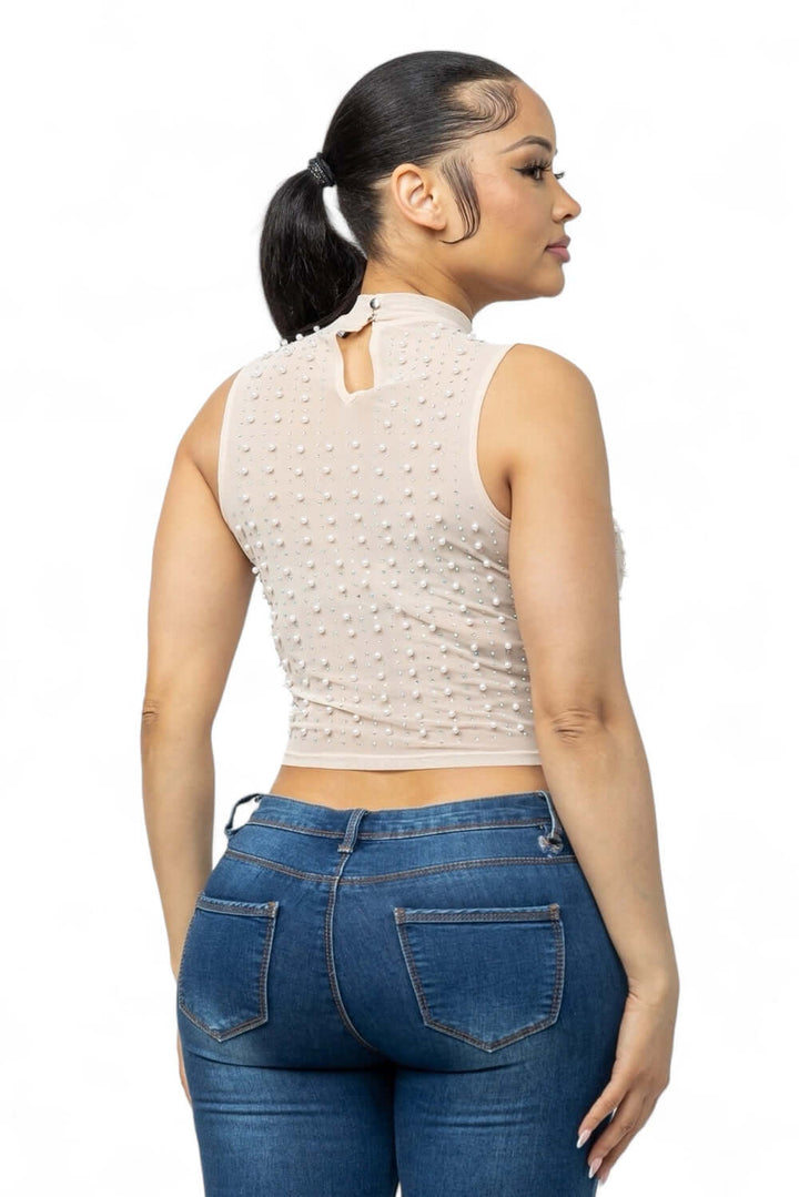 a woman in jeans and a top with holes on it