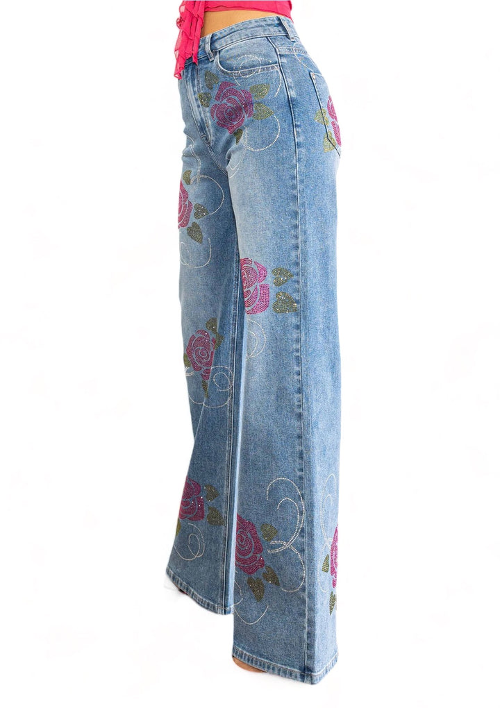 a pair of jeans with roses on them