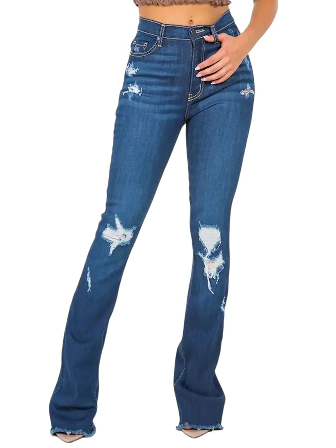 a woman wearing a crop top and jeans
