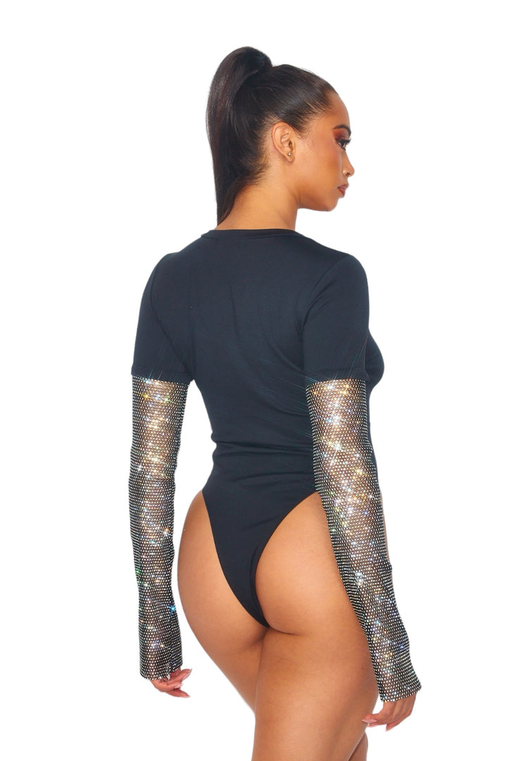a woman in a bodysuit with sequin sleeves