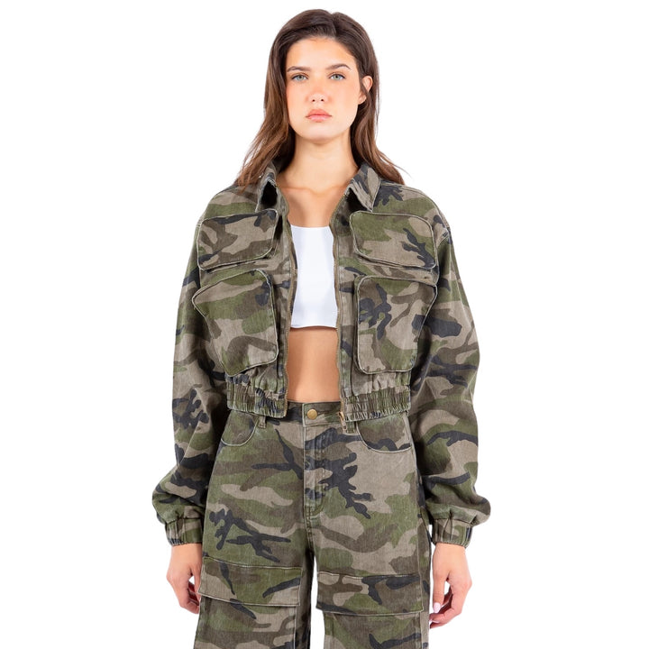 a woman wearing a camo jacket and pants