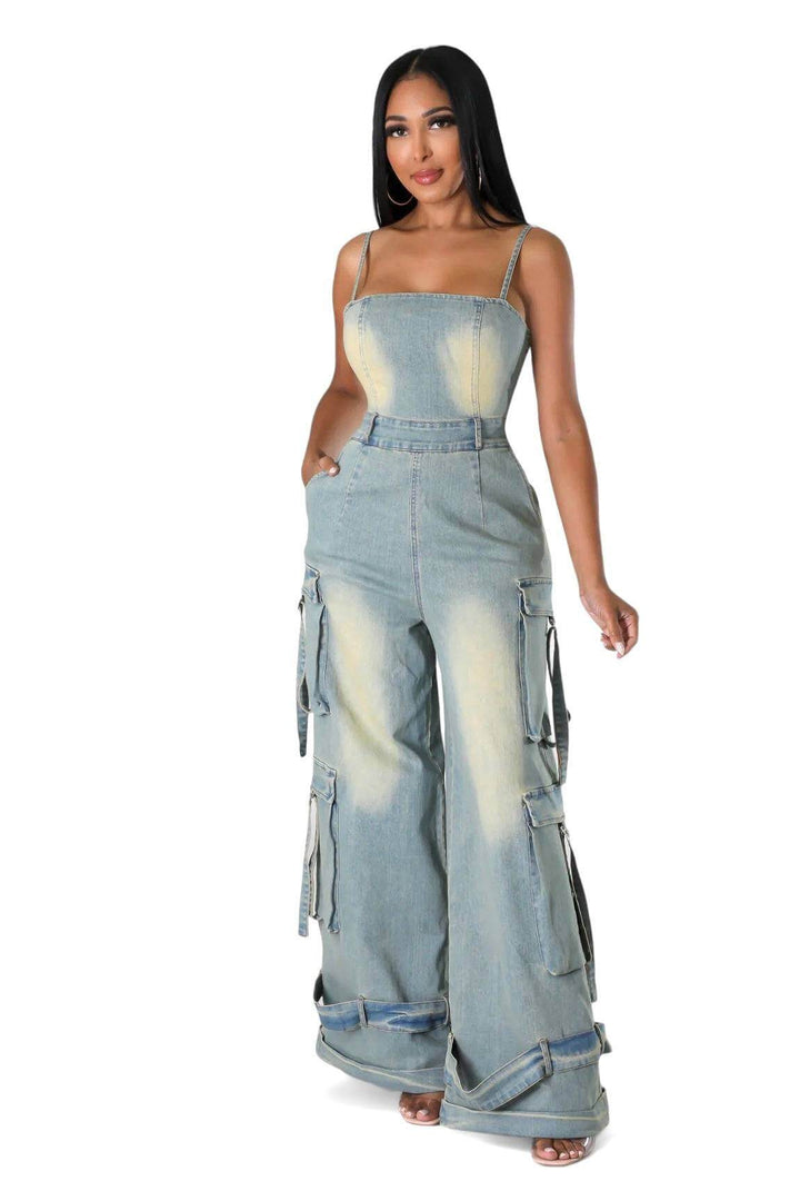 a woman wearing a denim jumpsuit and a tank top