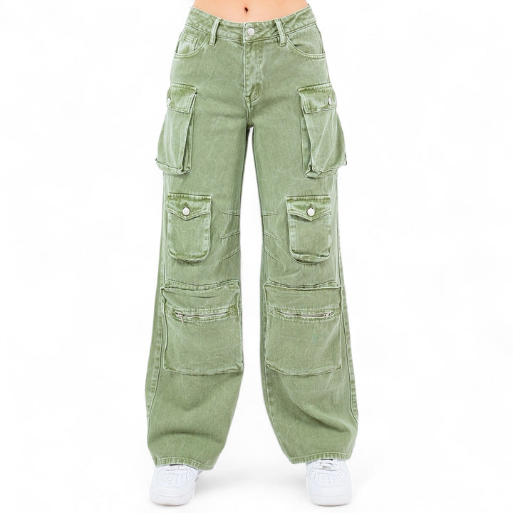 a woman wearing green cargo pants and white sneakers