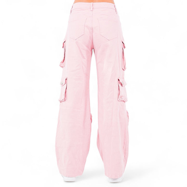 a woman wearing pink pants and a white top