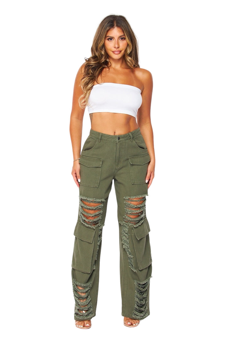 a woman in a white top and green pants