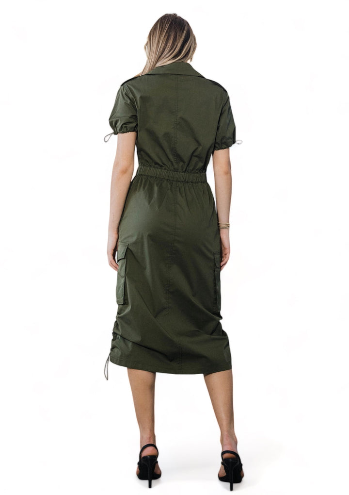 a woman in a green shirt dress