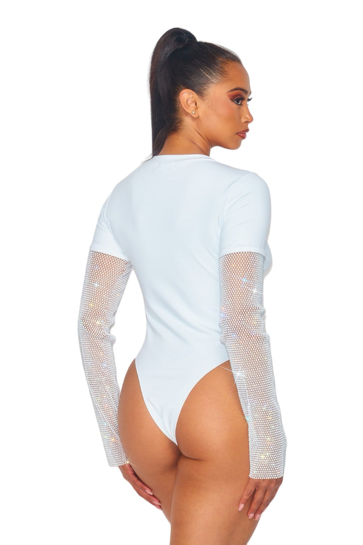 a woman wearing a white bodysuit with sheer sleeves