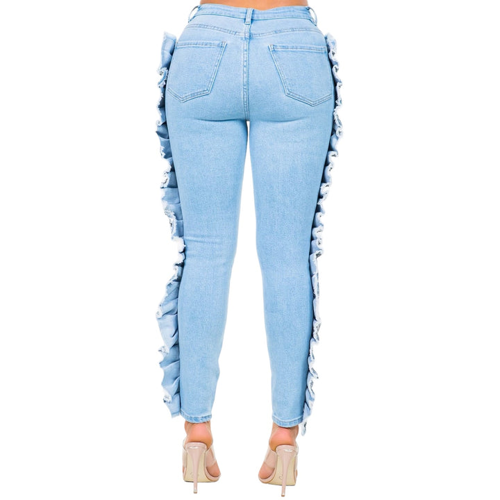 a woman wearing light blue jeans with ruffles on the side