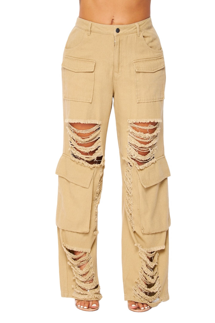 a woman is wearing a pair of pants with holes