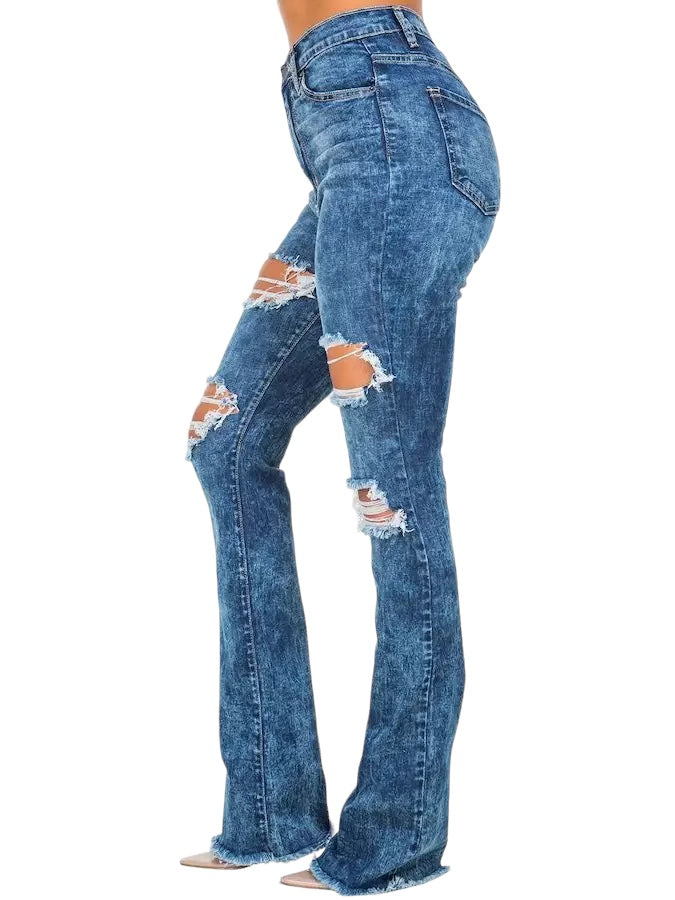 a woman in high rise jeans with ripped knees