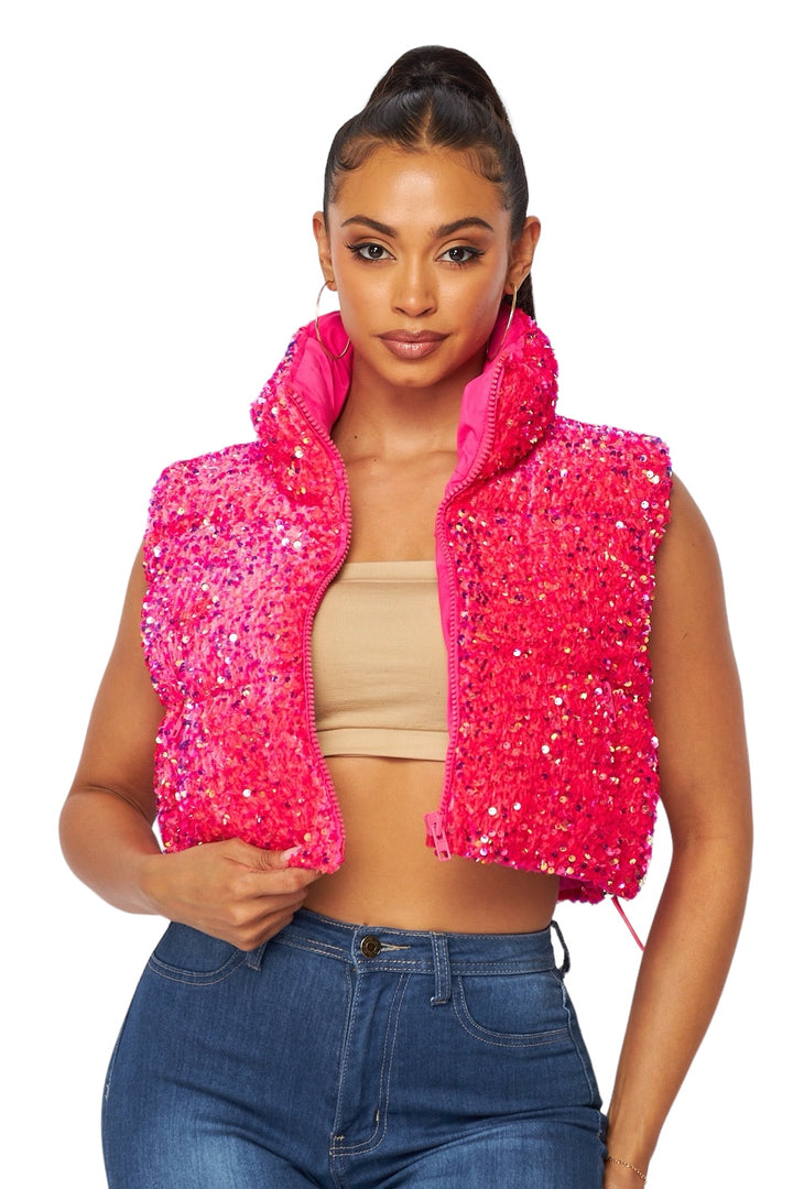 a woman wearing a pink jacket and jeans