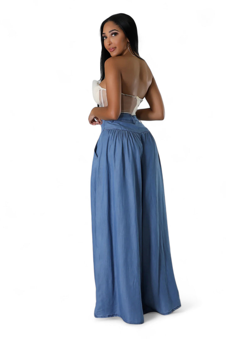 a woman wearing a blue skirt and a white top