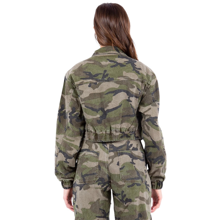 a woman in a camouflage print jumpsuit