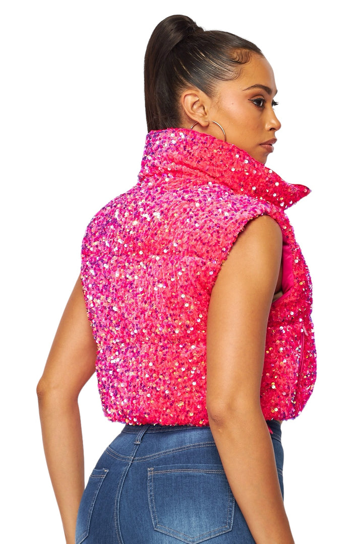a woman wearing a pink scarf and jeans