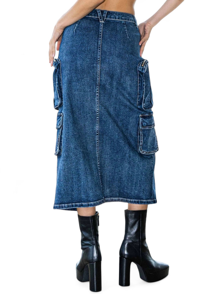 a woman wearing a jean skirt and black boots