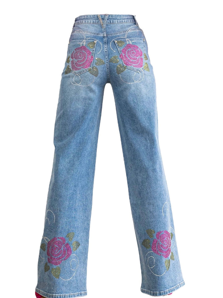 a pair of blue jeans with pink roses on them