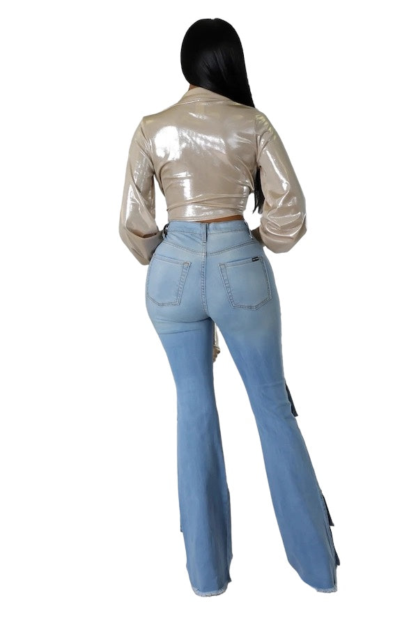 a woman wearing a metallic jacket and jeans