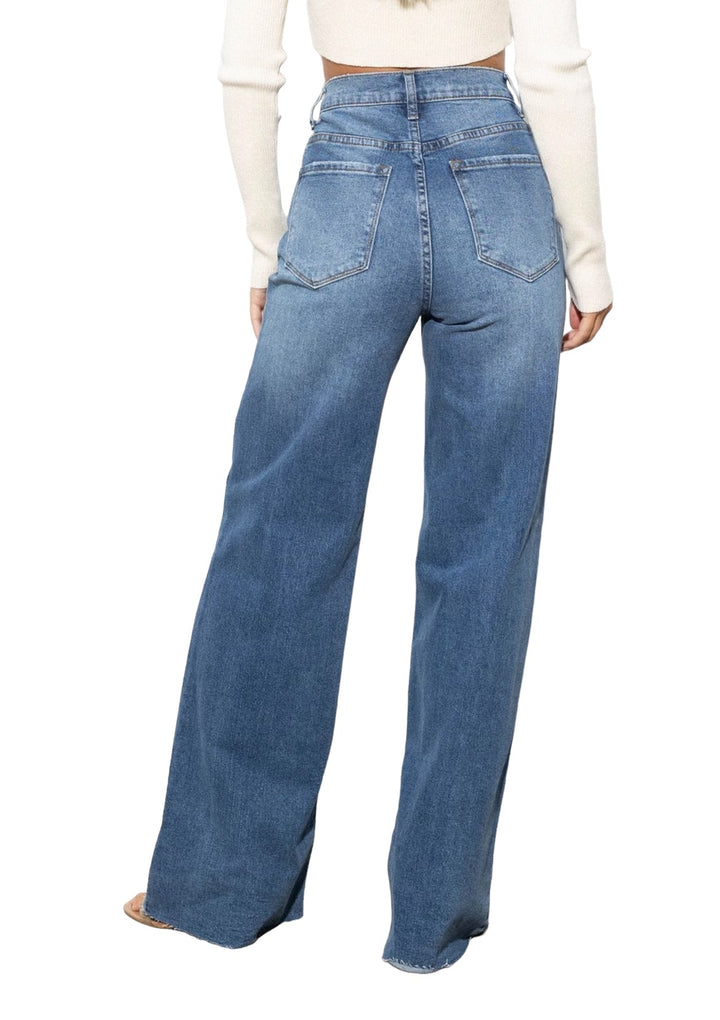 a woman wearing a white top and jeans