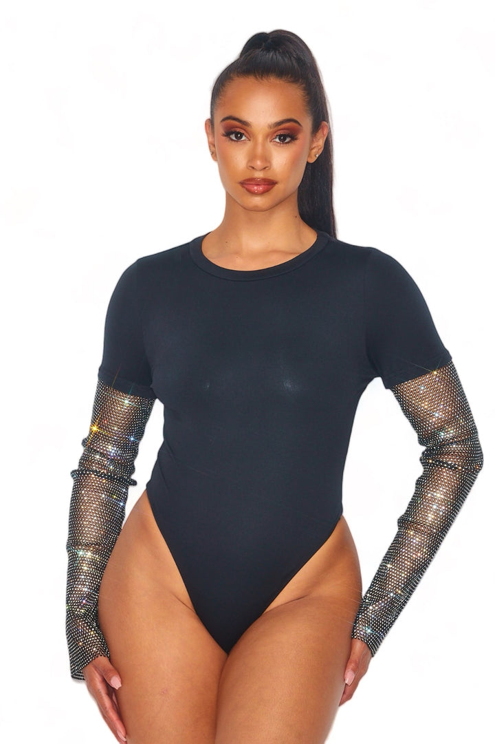 a woman wearing a bodysuit with mesh sleeves