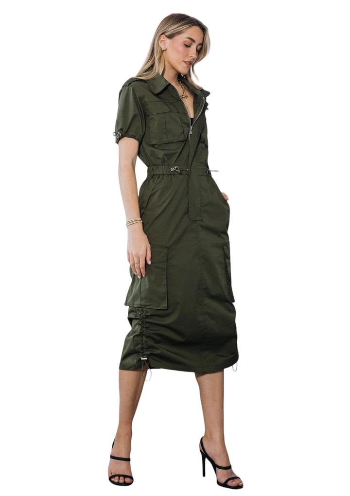 a woman wearing a green dress and heels
