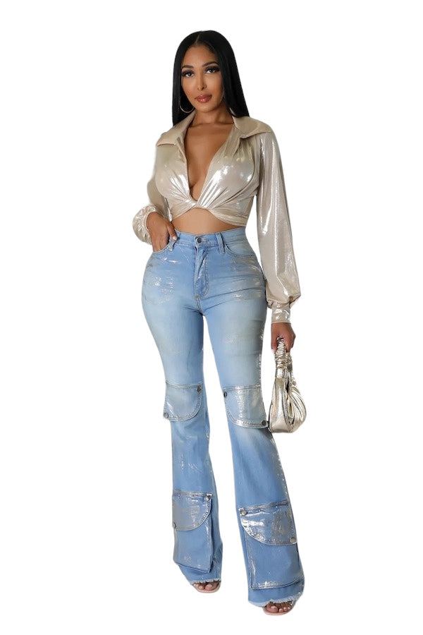 a woman in a gold top and jeans