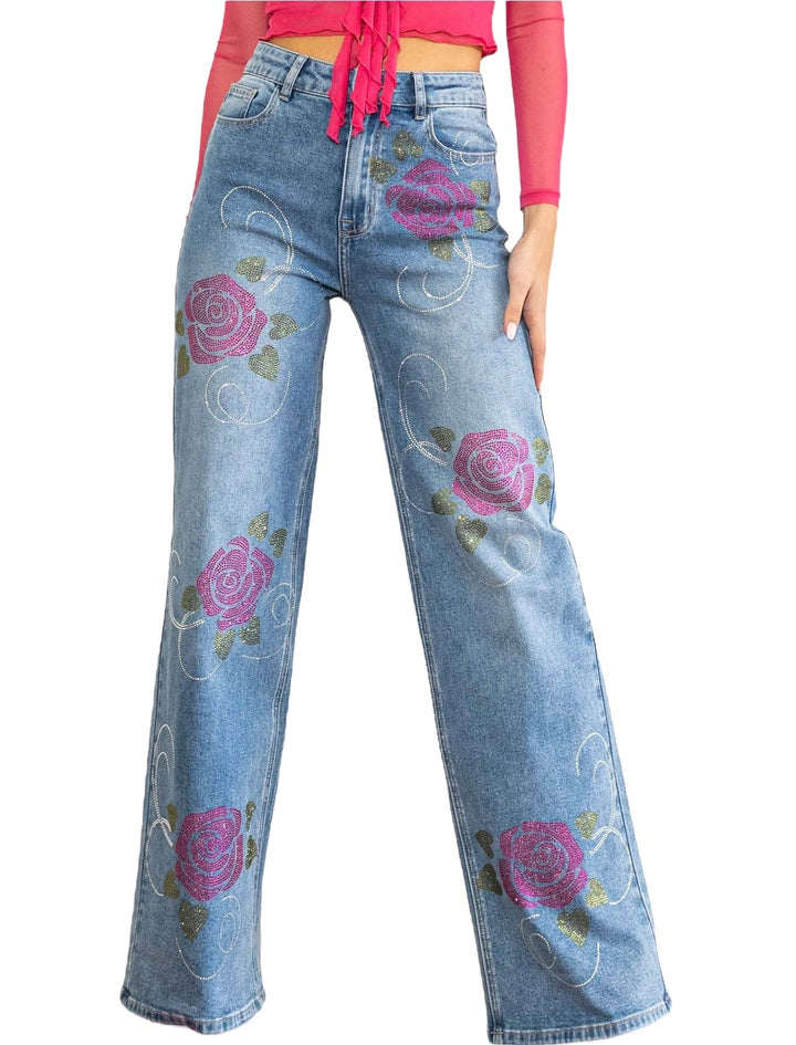 a woman is wearing a pair of jeans with roses on them
