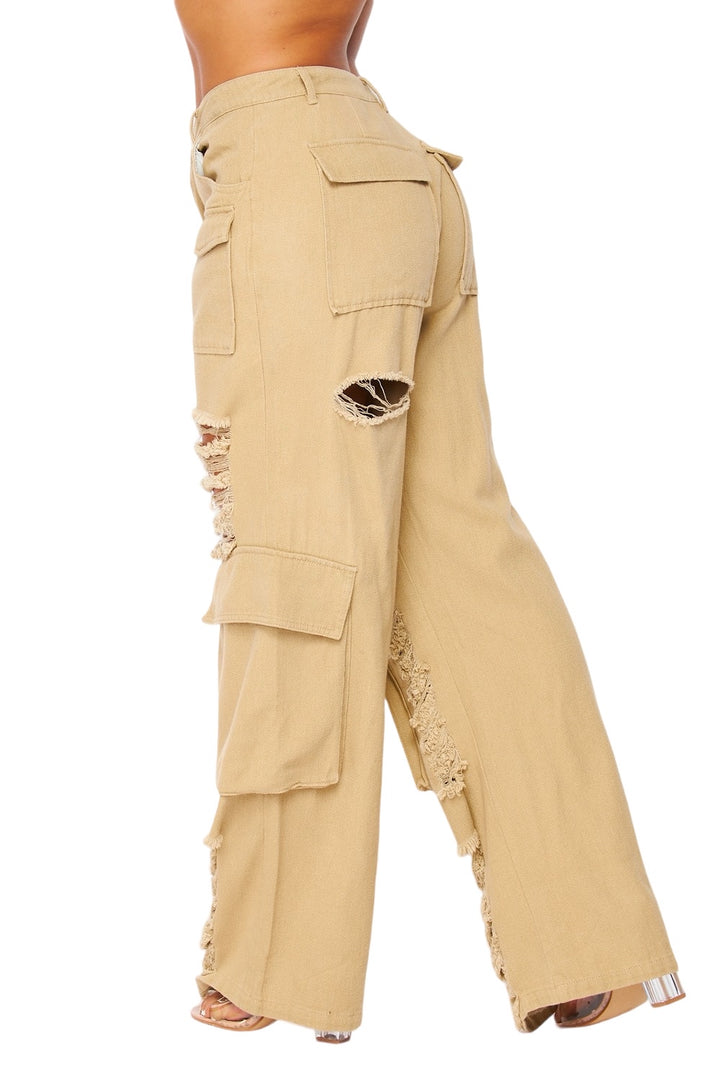 a woman is wearing a pair of pants with holes