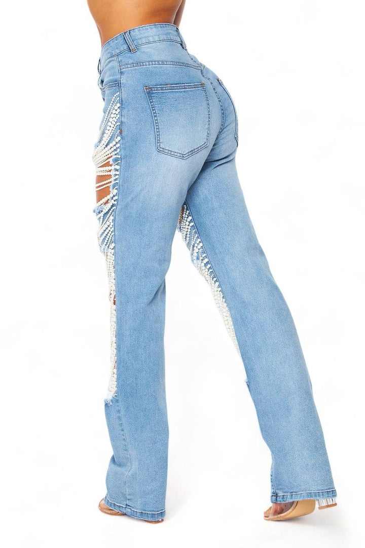 a woman in high waist jeans with ripped knees