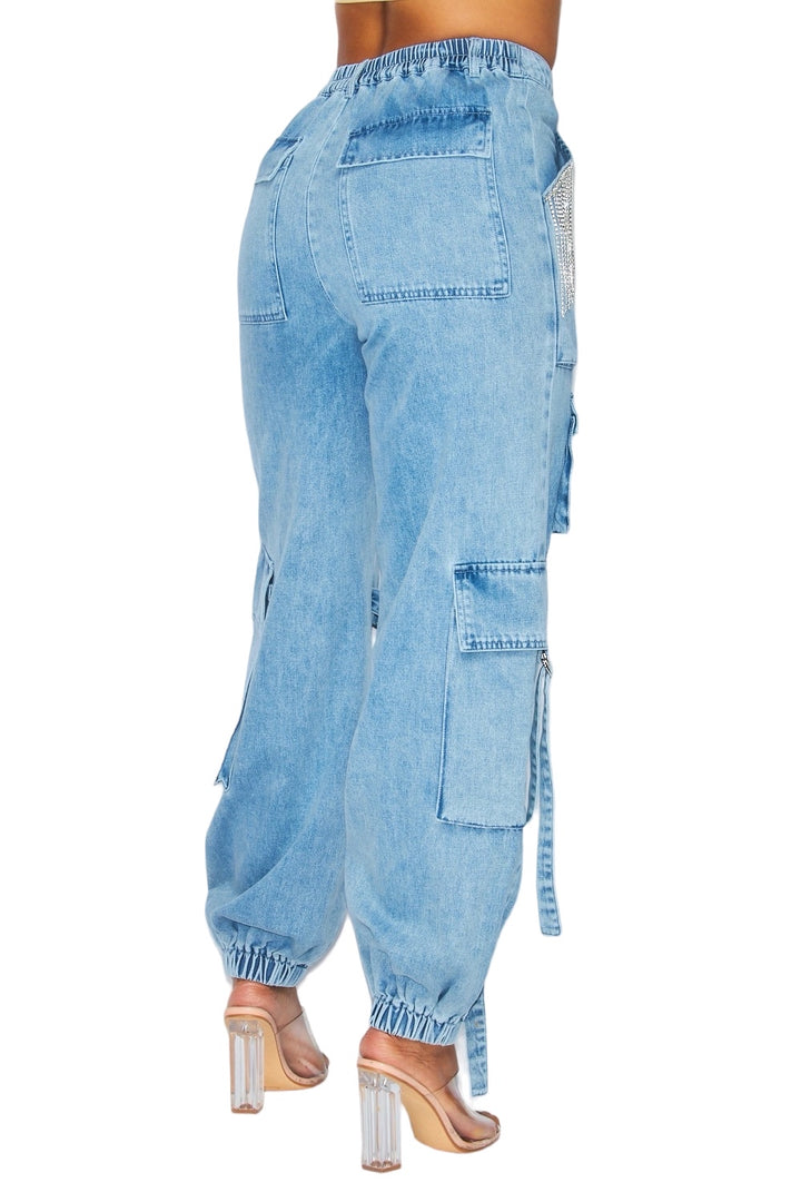 a woman wearing blue jeans and heels
