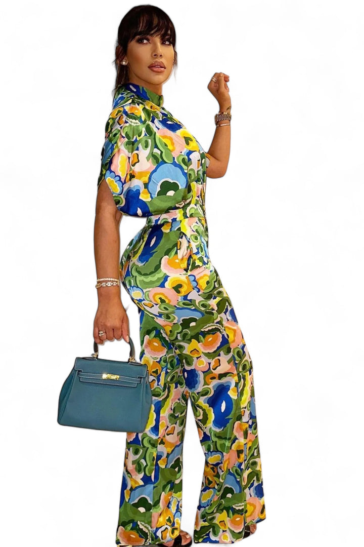 a woman in a colorful jumpsuit holding a purse