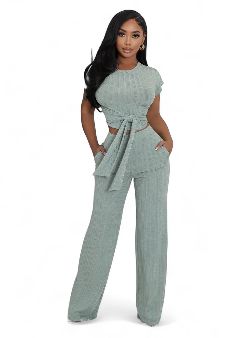a woman in a green top and pants