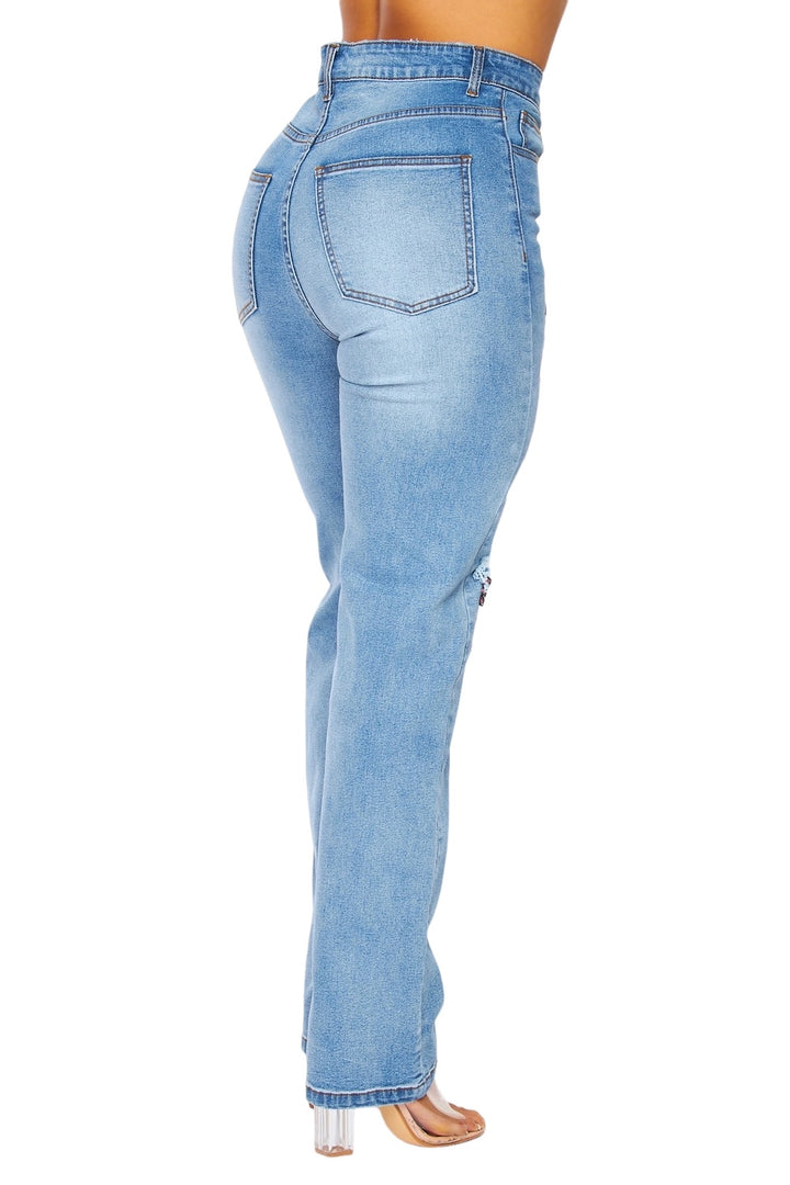 a woman in high rise jeans with her back to the camera
