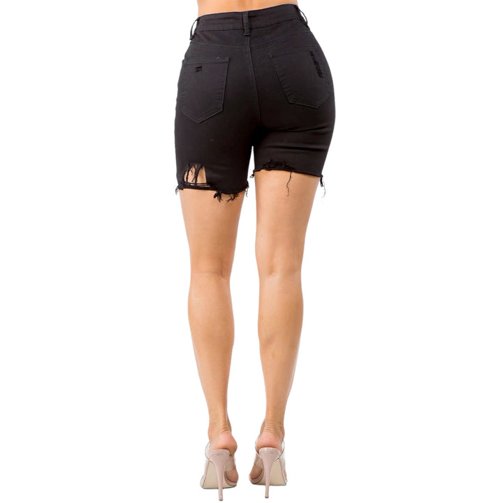 a woman wearing black shorts and high heels