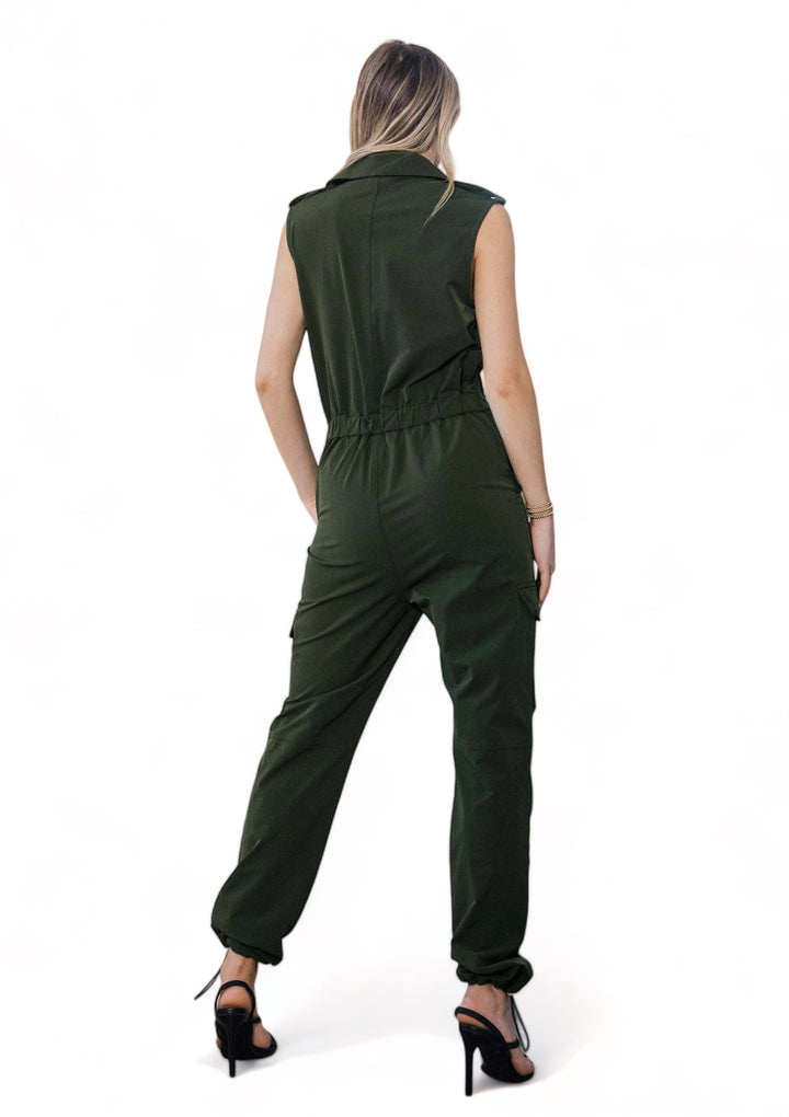 a woman wearing a green jumpsuit and heels