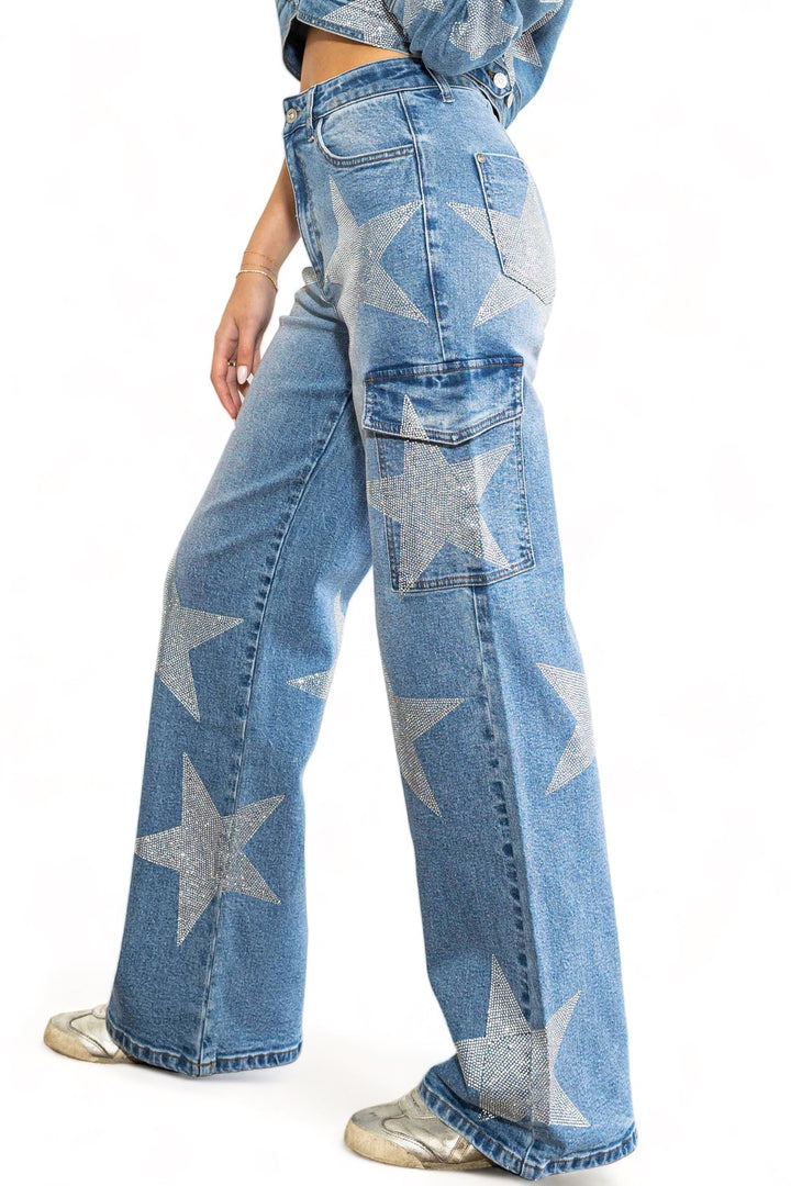 a woman wearing a pair of blue jeans with silver stars on them