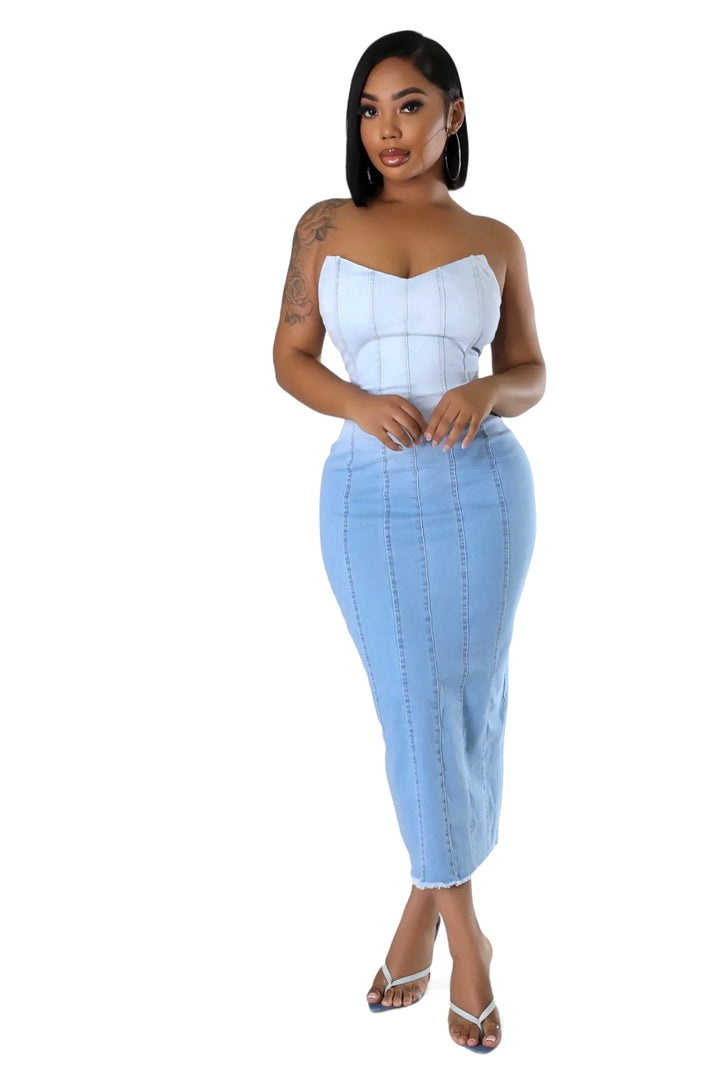 a woman in a white top and blue skirt