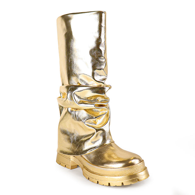 a pair of gold boots on a white background