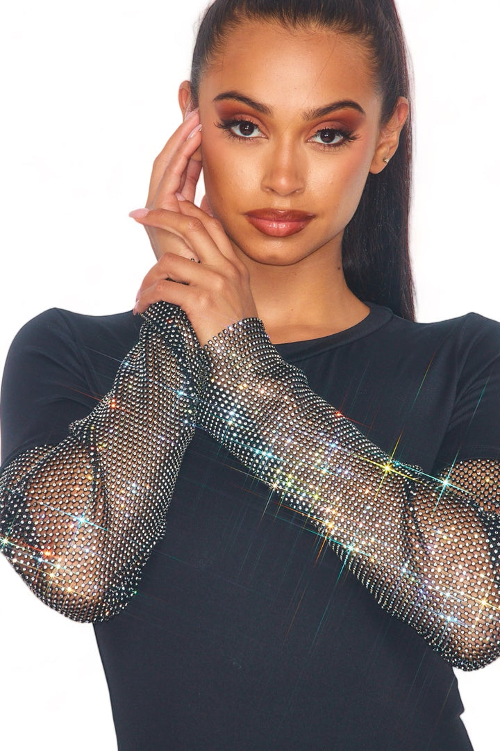 a woman with long hair wearing a black top