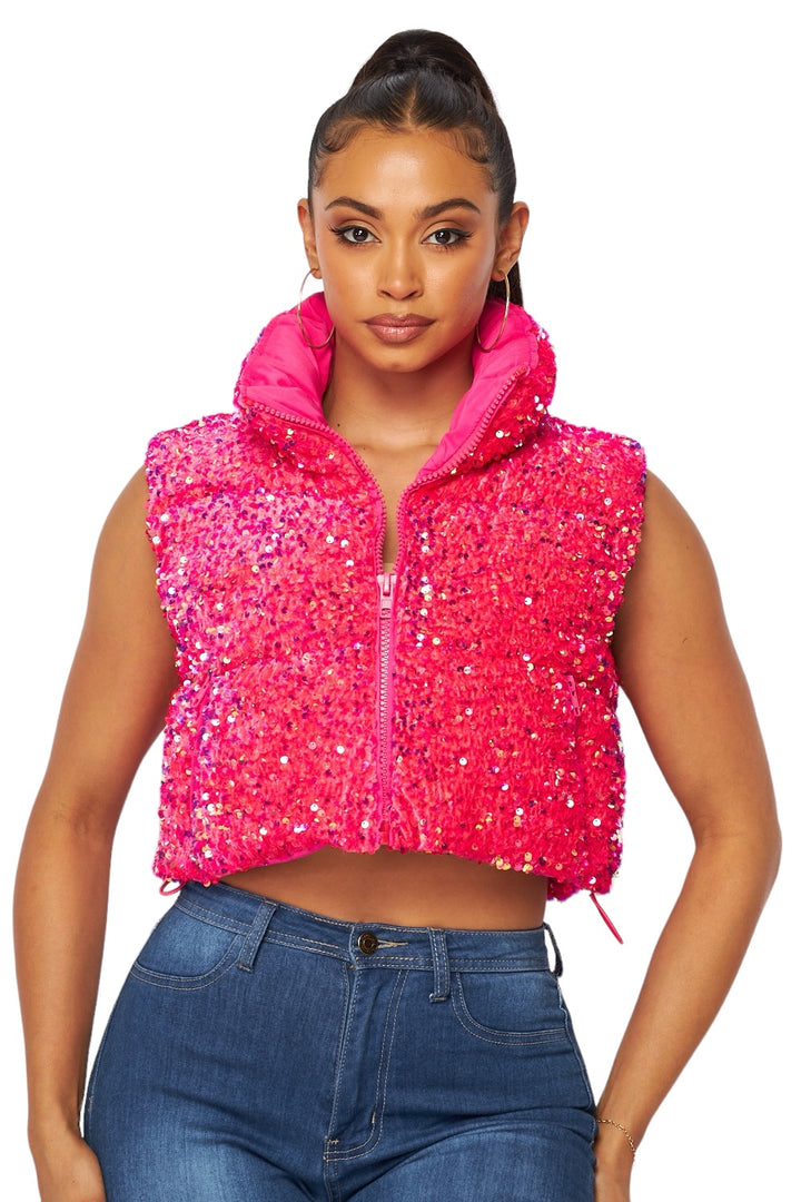 a woman wearing a pink jacket and jeans