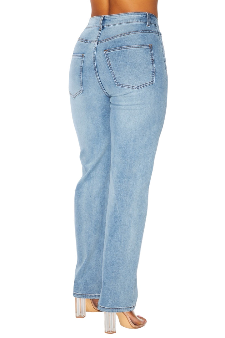 a woman wearing high rise jeans and heels