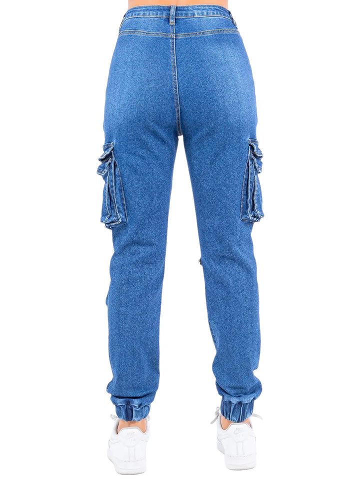 a woman in blue jeans with a white top