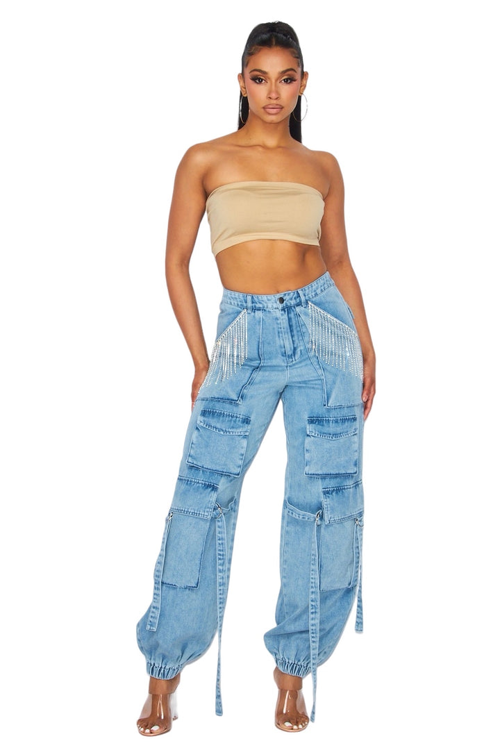 a woman wearing a crop top and jeans