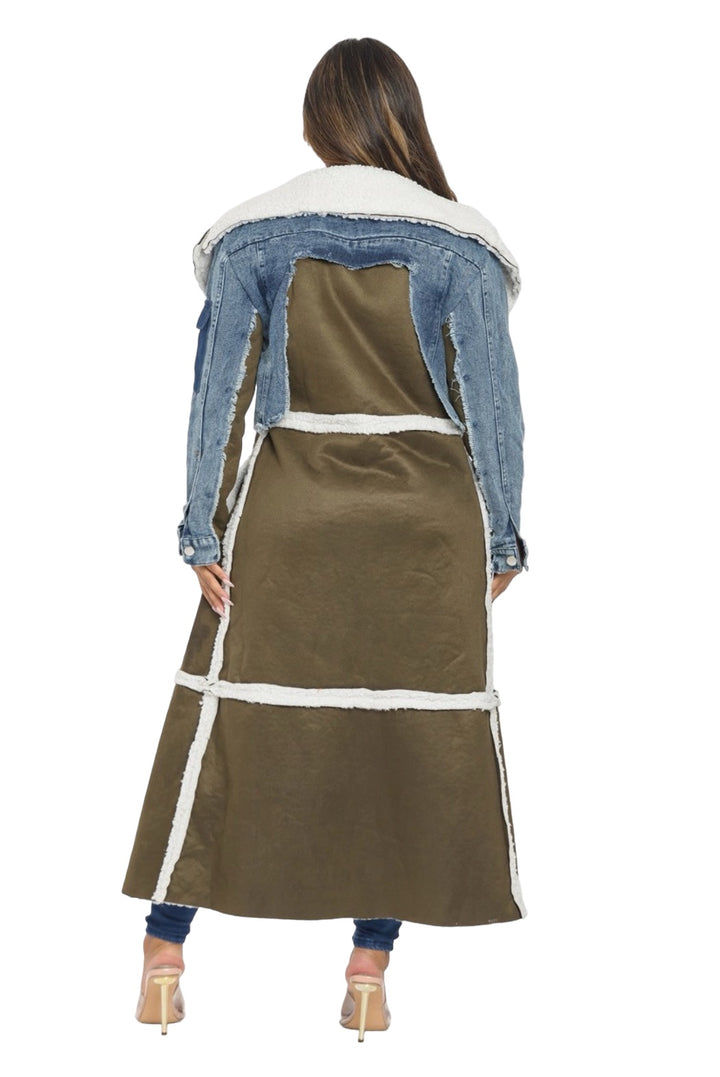 a woman wearing a denim jacket and a skirt