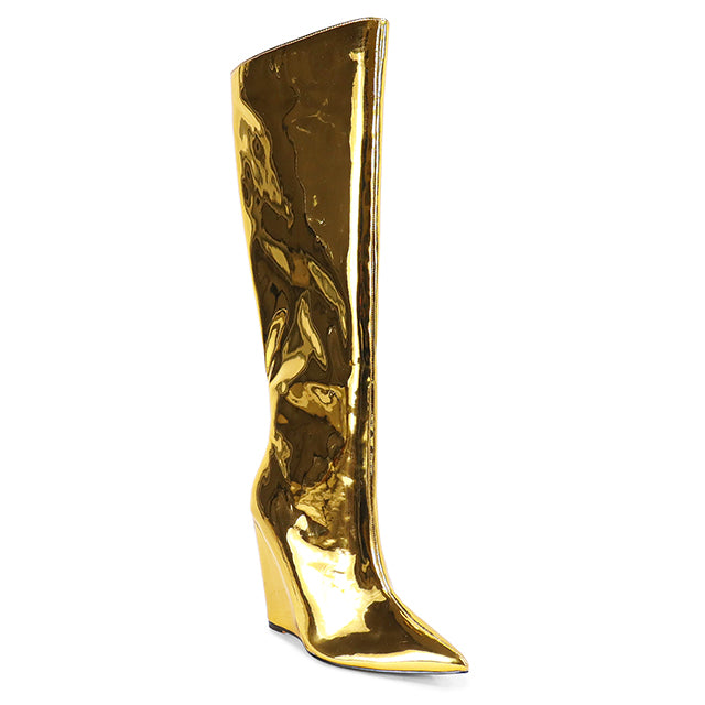 a tall gold boot with a high heel