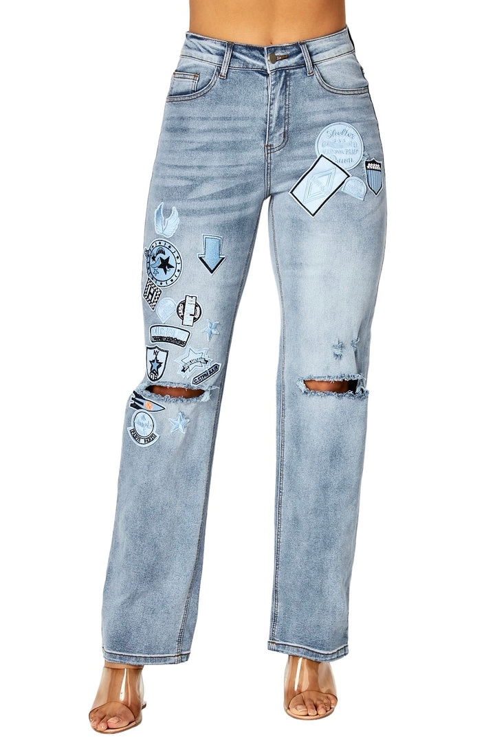 a woman wearing a pair of jeans with patches