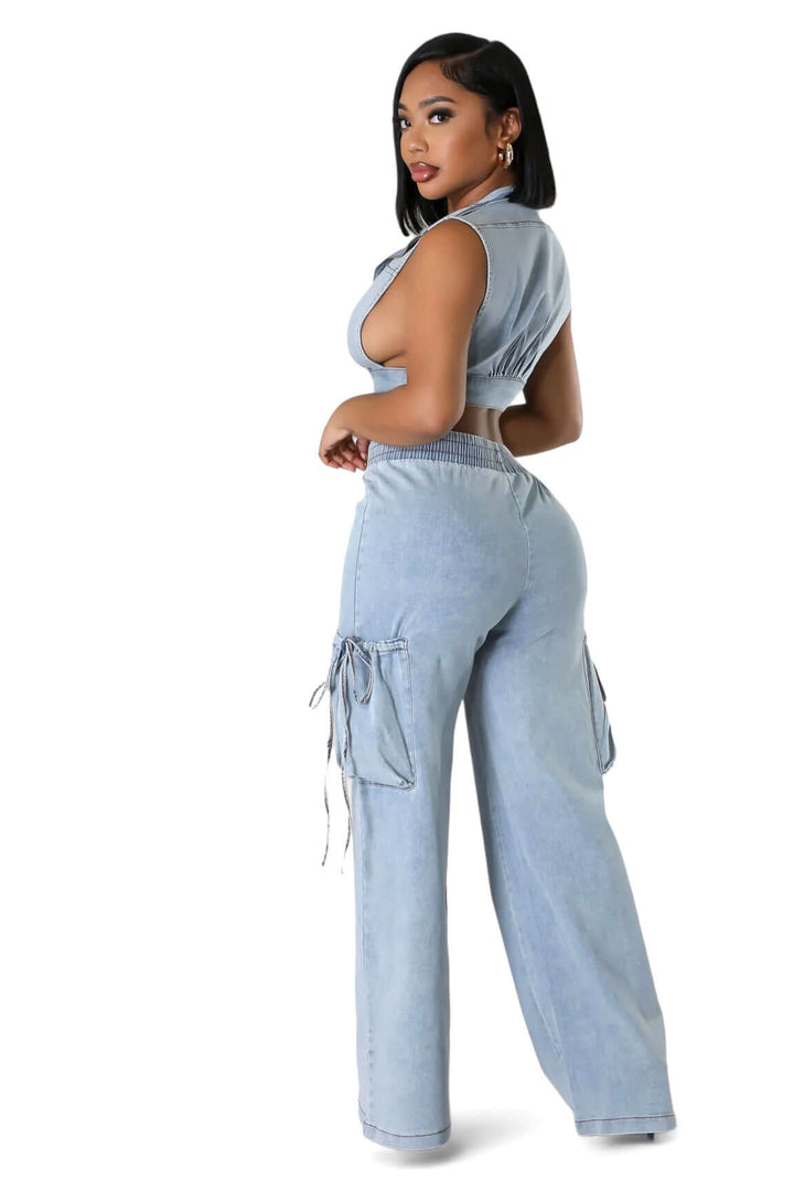 a woman wearing a blue jumpsuit and heels